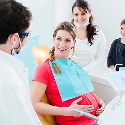 Pregnant woman at dentist before treatment