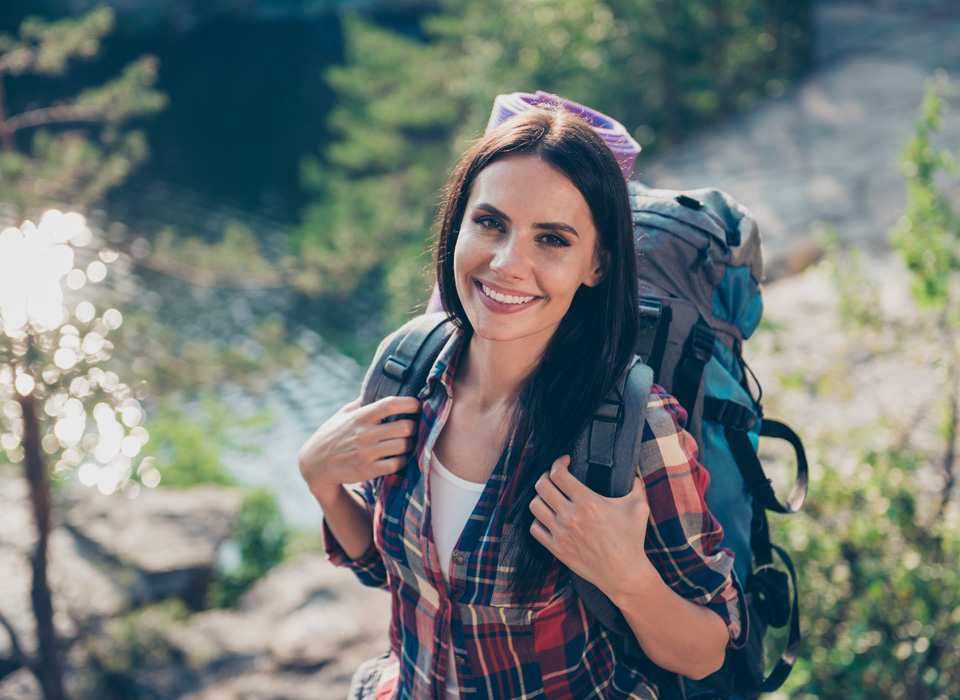 Portrait of adorable beautiful nice lovely cute cheerful long-haired girl, wearing casual checkered shirt, backpacking, wandering, exploring the world.